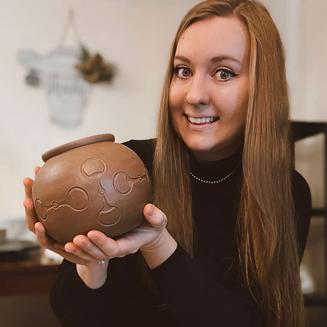 Christy Rosalez holding one of her pots.